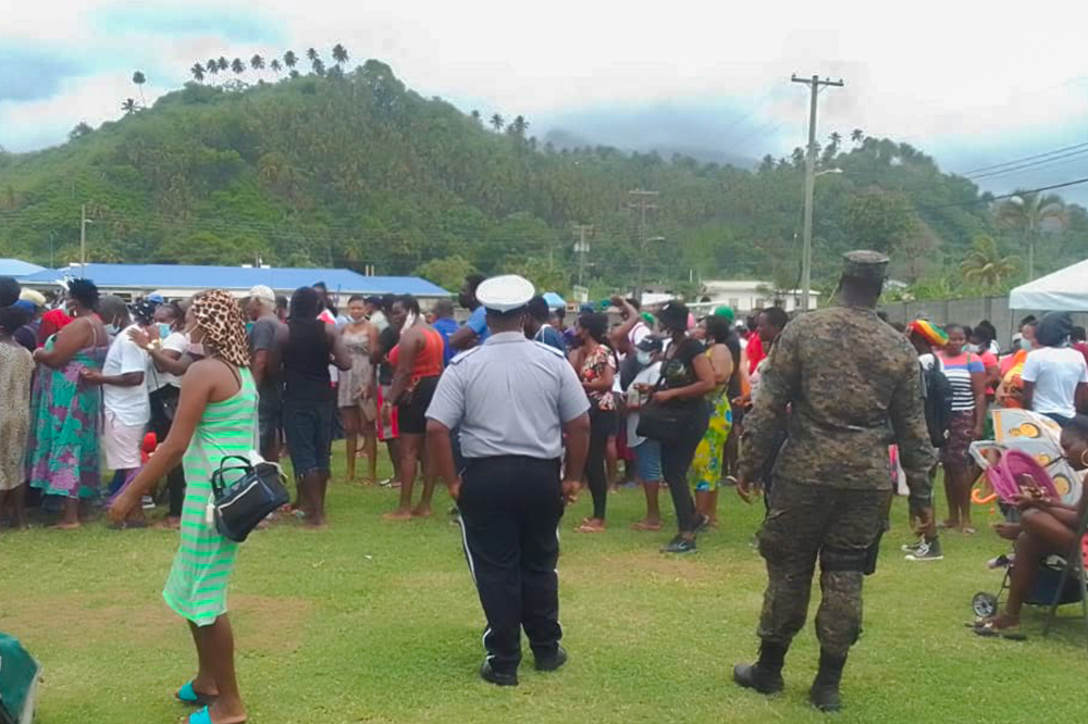 Residents gather at Chili Playing Field to collect BOSVG cards  under the Government’s Volcanic Eruption Emergency Programme